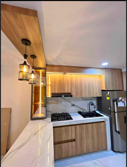 Cocina integral moderna en madera cálida con encimera clara